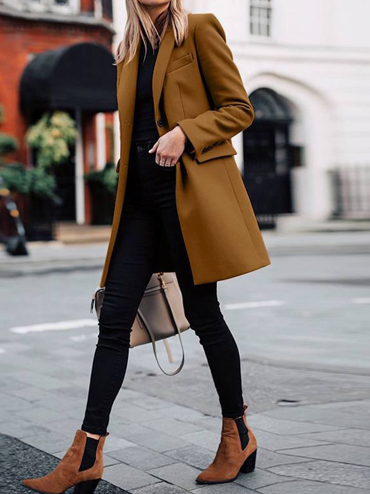 черные кожаные ботинки и бежевое пальто