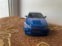 Модель автомобиля Nissan Skyline GT-R R34 инерционная машинка 1:28 синяя длина 14.5см, со светом и звуком #55, Ляйсан М.